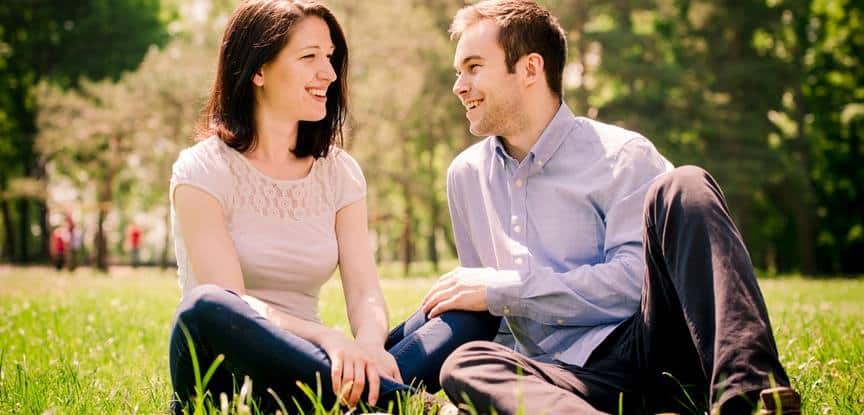 casal feliz sentado na grama